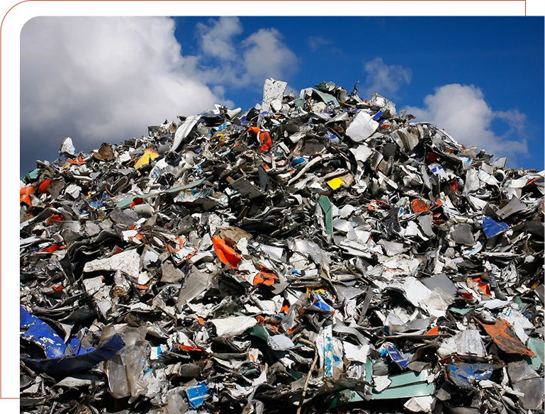 A pile of trash sitting in the middle of a field.