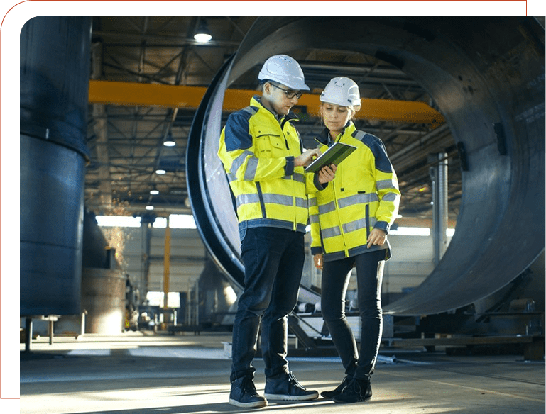 Two people in yellow jackets and hard hats