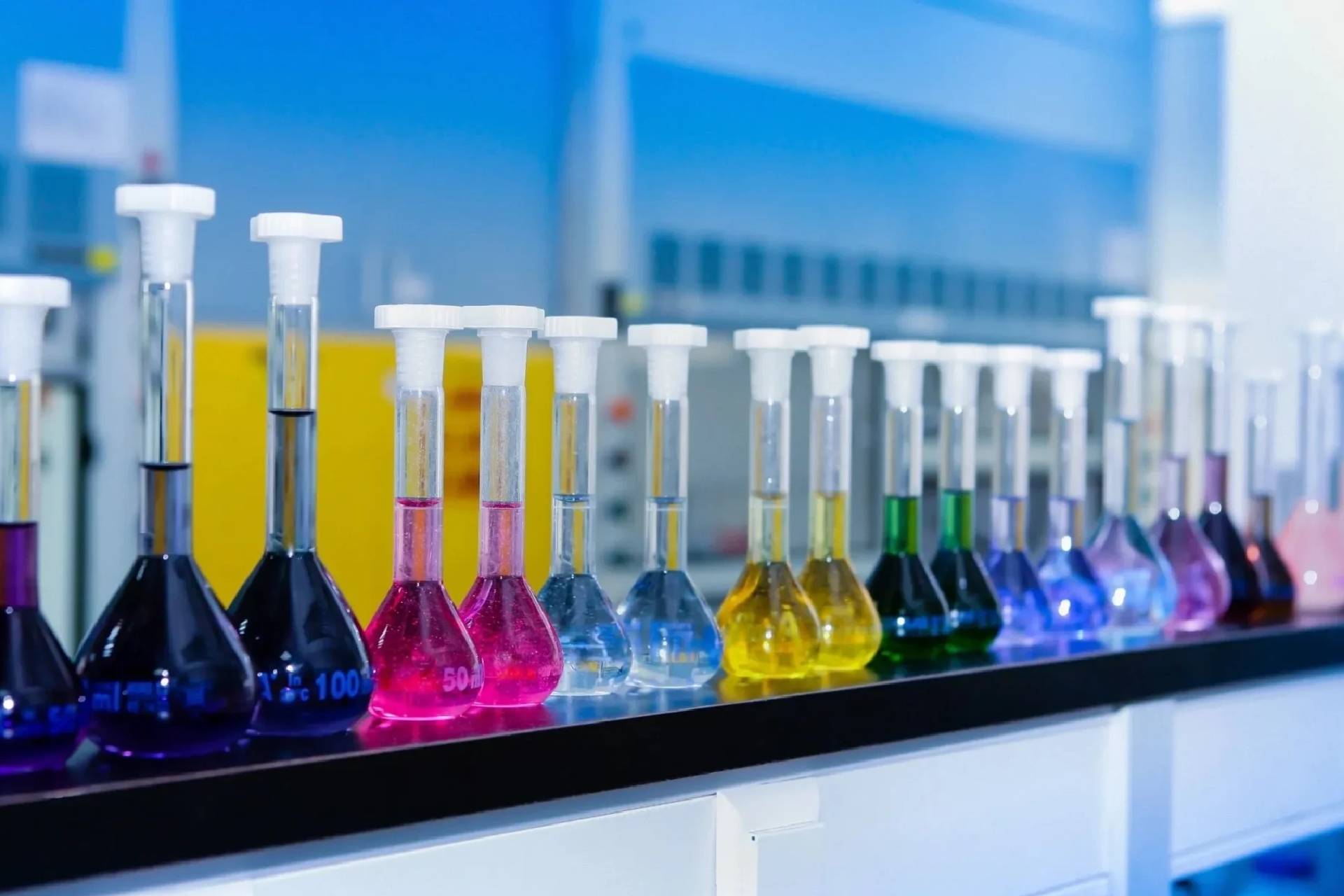 A row of colorful test tubes sitting on top of a table.