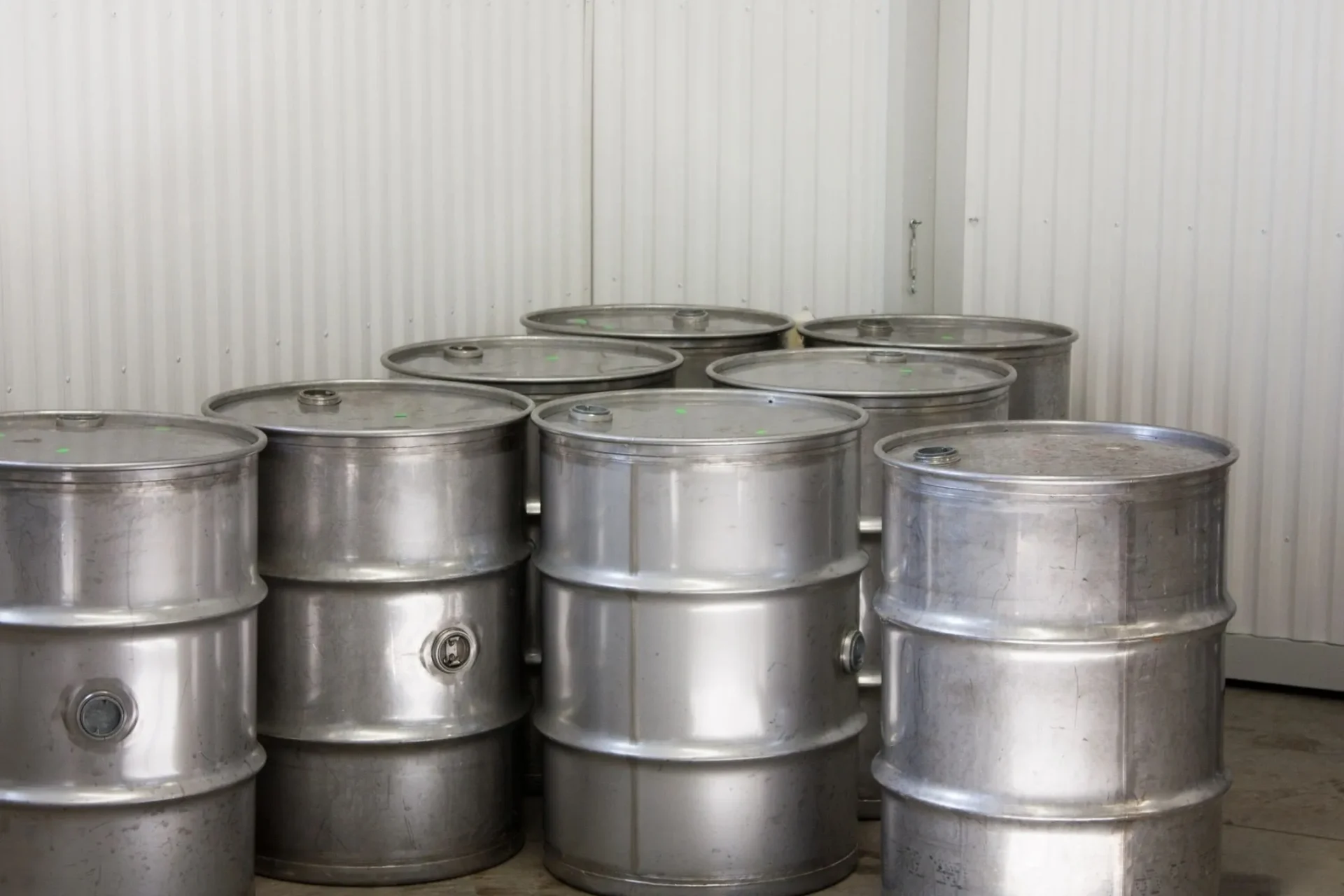 A bunch of metal barrels sitting in a room