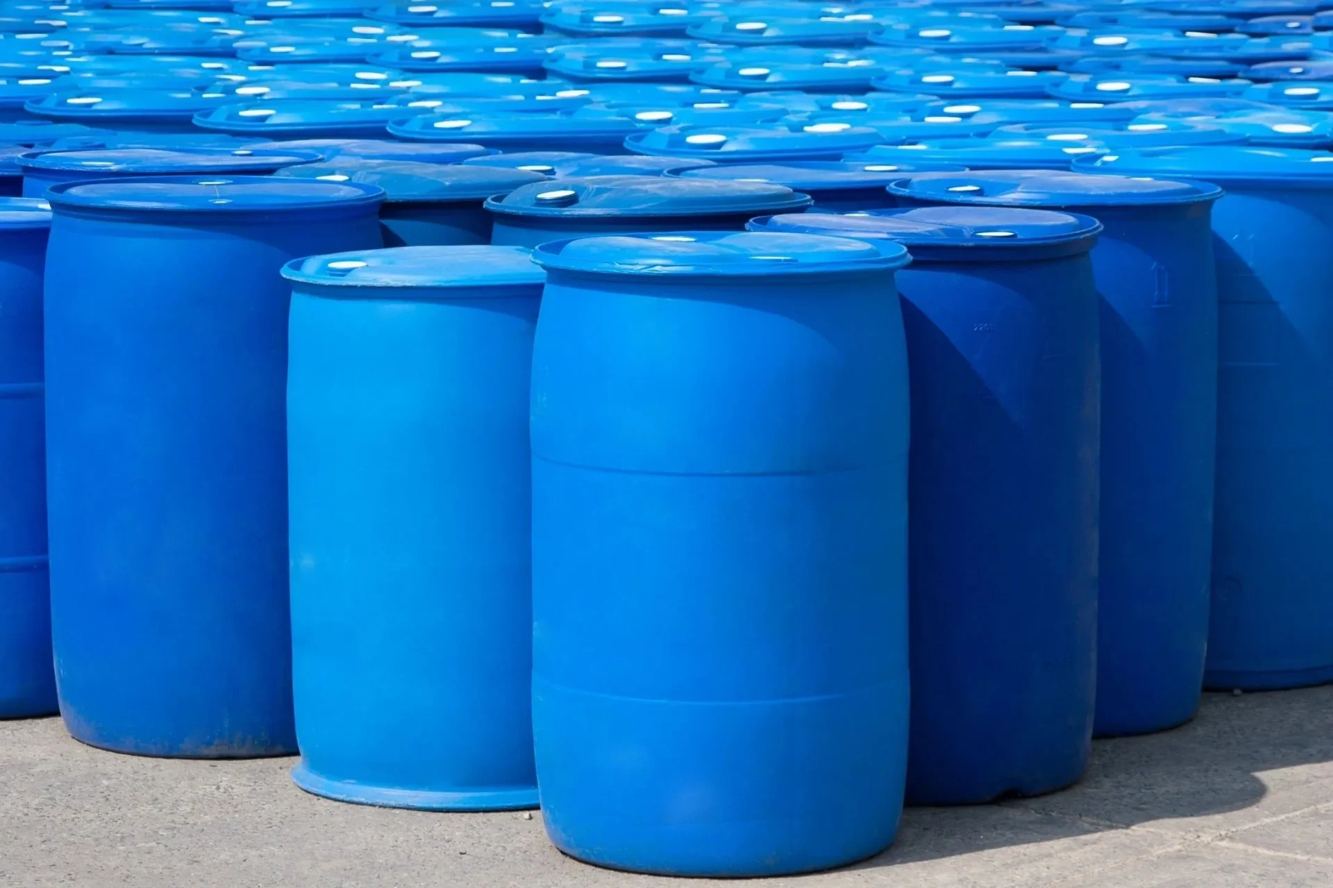 A bunch of blue barrels are lined up